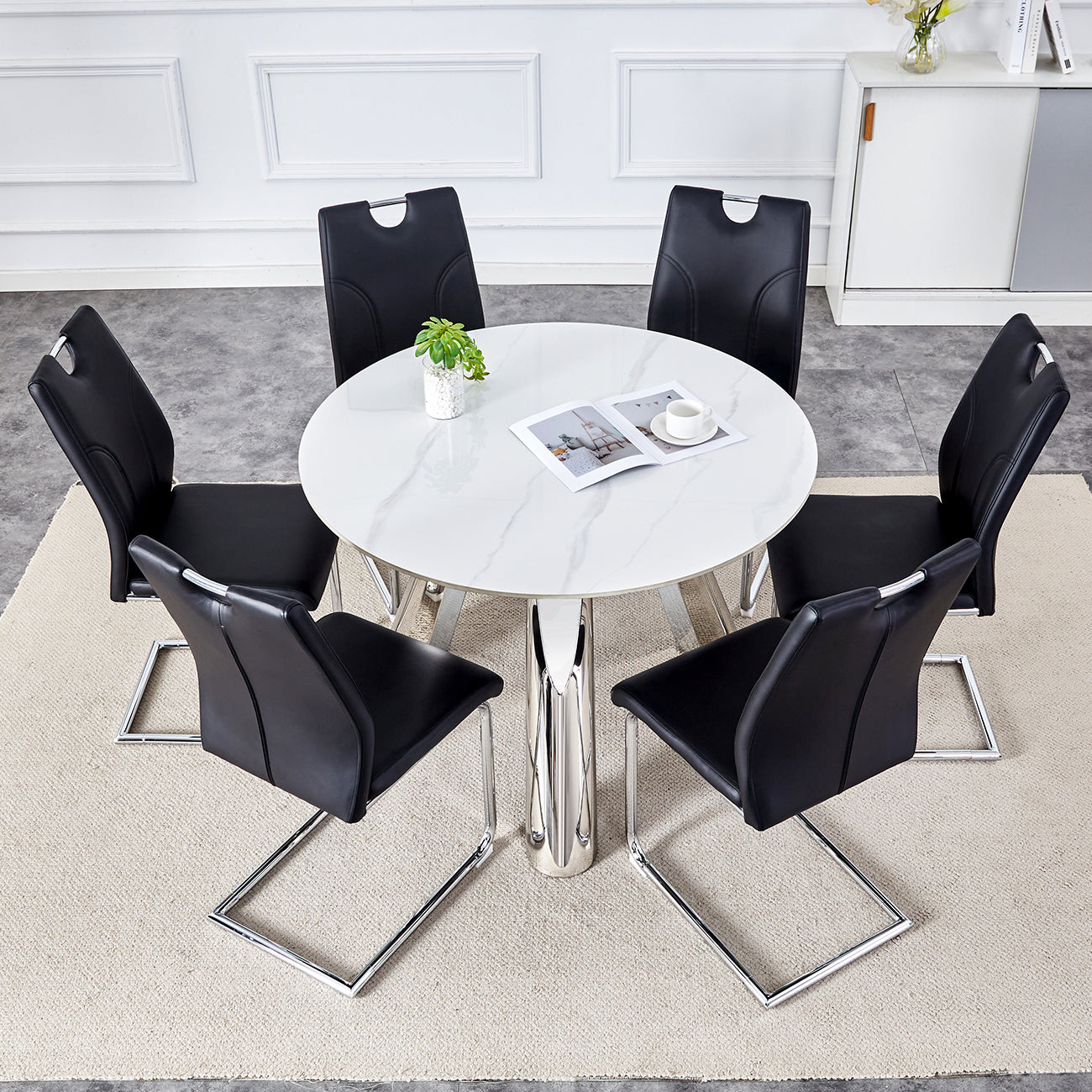 Table and chair set.A 42-inch stainless steel leg round table .Paired with 6 Uniquely designed Black Dining Chairs With Silver Metal Leg.Sintered Stone Tabletop,Stainless Steels Table Legs.